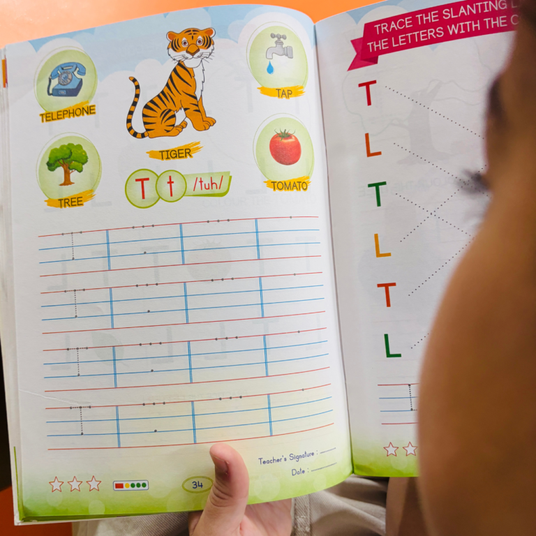 Inside pages of Kenbee Book Alphabet Part-A featuring letter T tracing and vocabulary activities